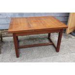 A 1930s teak draw leaf dining table, on square stretchered supports, 84" wide x 33" deep x 28 1/2"