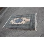 A Middle Eastern rug with central medallion and multi-borders in shades of natural and grey, 48" x