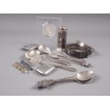 A silver pepperette with blue glass liner, two silver vesta cases, a silver spoon and pusher set,