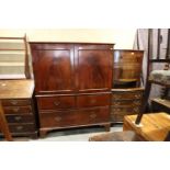 An early 19th century mahogany linen press, the upper section fitted trays enclosed two doors over