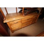 An oak coffee table, fitted six double sided drawers, on square taper supports, 46" wide x 23"deep x