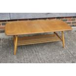 An Ercol elm 459 coffee table with spindle undertier, 41" wide x 18" deep x 14 1/2" high