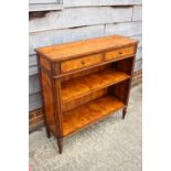 A Theodore Alexander burr walnut bookcase of Louis XVI design, fitted two drawers over open shelves,