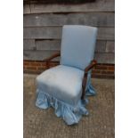 A carved walnut open armchair, upholstered in a blue fabric, on cabriole claw and ball supports, and