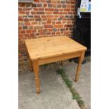 A waxed pine kitchen table, on turned supports, 37" wide x 24" deep x 30" high