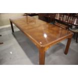 An American figured walnut and banded extending dining table with two extra leaves, on square