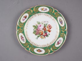 An early 19th century Continental porcelain dessert plate with reserved panels of flowers, on a