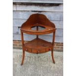 A 19th century mahogany bowfront corner washstand, fitted one drawer, on splay supports, 25" wide