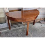 A 19th century mahogany demi-lune side table, on chamfered supports, 47" wide