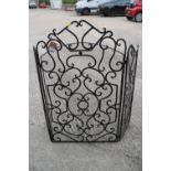 A wrought iron scroll work three-fold firescreen, centre panel 24" wide x 41" high