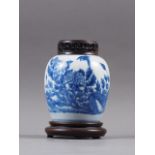 A Chinese blue and white floral bird decorated pot-pourri jar with pierced hardwood cover and stand,