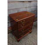 A Georgian style figured mahogany chest of four long graduated drawers, on bracket supports, 24"