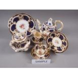 A 19th century Worcester part teaset, decorated with floral sprays and blue and gilt borders (