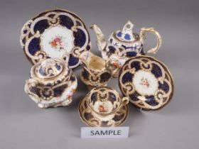 A 19th century Worcester part teaset, decorated with floral sprays and blue and gilt borders (