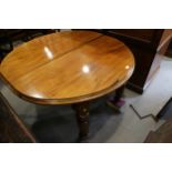 A 19th century walnut oval extending dining table with two extra leaves, on fluted supports, 84" max