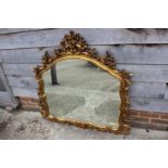 A carved gilt frame wall mirror with shaped plate, 31" high x 36" wide