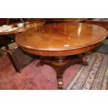 A late 19th century mahogany circular extending dining table with one extra leaf, on turned column