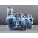 A Chinese blue and white flared rim vase, decorated with two figures carrying an urn and birds and