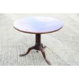 A 19th century mahogany circular tilt top table, on turned column and tripod splay supports, 30" dia
