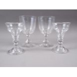 A pair of 19th century cut glass goblets with faceted stems and a pair of ogee bowl glasses with