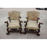 A pair of Italian carved walnut armchairs of 17th century design with tapestry seats, backs and
