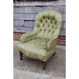 A 19th century tub-shape armchair, button upholstered in a green floral brocade, on turned and