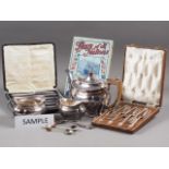 An assortment of silver plate, including a three-piece teaset, boxed and loose cutlery, including