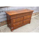 A figured mahogany dressing chest of Louis XVI design, fitted mirror and slides over four drawers,