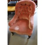 A late 19th century spoon back occasional chair, button upholstered in a pink velour, on turned