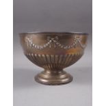 A silver bowl with embossed swag and fluted decoration, on a circular foot, 14.4oz troy approx