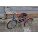 A child's Pashley tricycle, in blue and red, 29 1/4" high (up to handles)