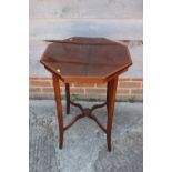 An Edwardian walnut octagonal and satinwood banded occasional table, on splay supports united by