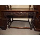 A 19th century carved oak table centre, fitted one drawer, on barley twist and stretchered supports,