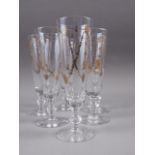 A set of six Spanish wheel engraved and gilt decorated champagne flutes, formerly the property of