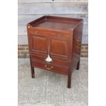 A Georgian mahogany tray top bedside stand, fitted drawer over cupboards and deep drawer, on moulded