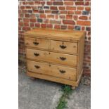 A waxed pine chest of two short and two long drawers with brass handles, on turned supports, 36"