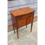 An Edwardian satinwood and banded flap top sewing table, fitted one faux drawer over cupboard, on