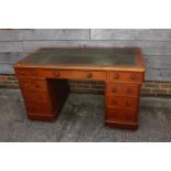 A Victorian mahogany double pedestal desk, inset green leather top over nine drawers, on block base,