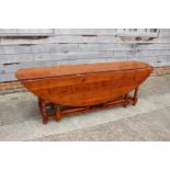 A yew wood wake table, on double gate leg turned and stretchered supports, top 90" x 58" x 29 1/2"