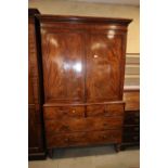 A 19th century mahogany linen press, the upper section enclosed two doors over two short and three