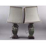 A pair of Chinese bronze archaic design table lamps with ring handles, on square hardwood bases