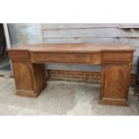 A 19th century mahogany breakfront double pedestal sideboard, fitted three frieze drawers over