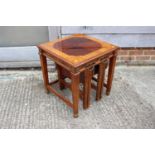 A mahogany and ash banded nest of three occasional table, on reeded supports and brass feet, 20"