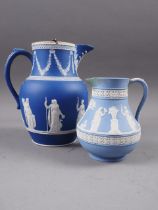 A 19th century Wedgwood dark blue jasperware water jug with silver lid, 7 1/2" overall, decorated