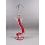 A Venetian red, clear and gilt speckled glass table lamp, formed as a dolphin 18 1/2" high