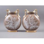 A pair of mid 19th century porcelain pate-sur-pate two-handle moon flasks with fern and insect