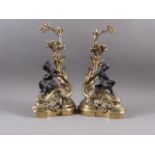 A pair of 19th century Rococo brass and bronze andirons with scrollwork and figure decoration, 18"