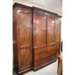 A late 19th century figured mahogany breakfront wardrobe with two sentry box hanging compartments