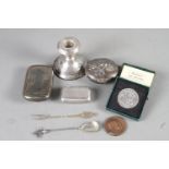 A silver pocket snuffbox, dated 1916, two other snuffboxes, a filled silver candlestick, two