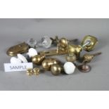 A collection of cast brass door handles, knobs and other door furniture